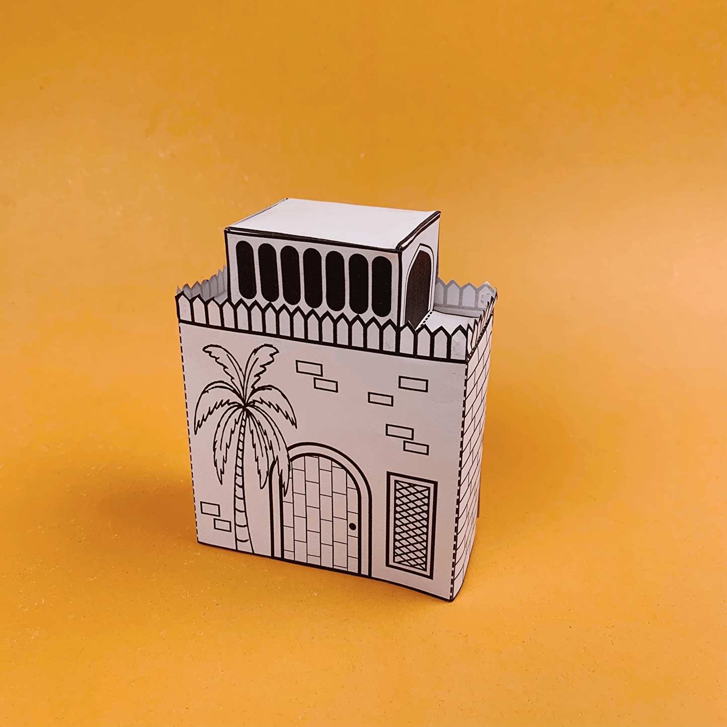 Kids assembling Arabian desert village paper houses